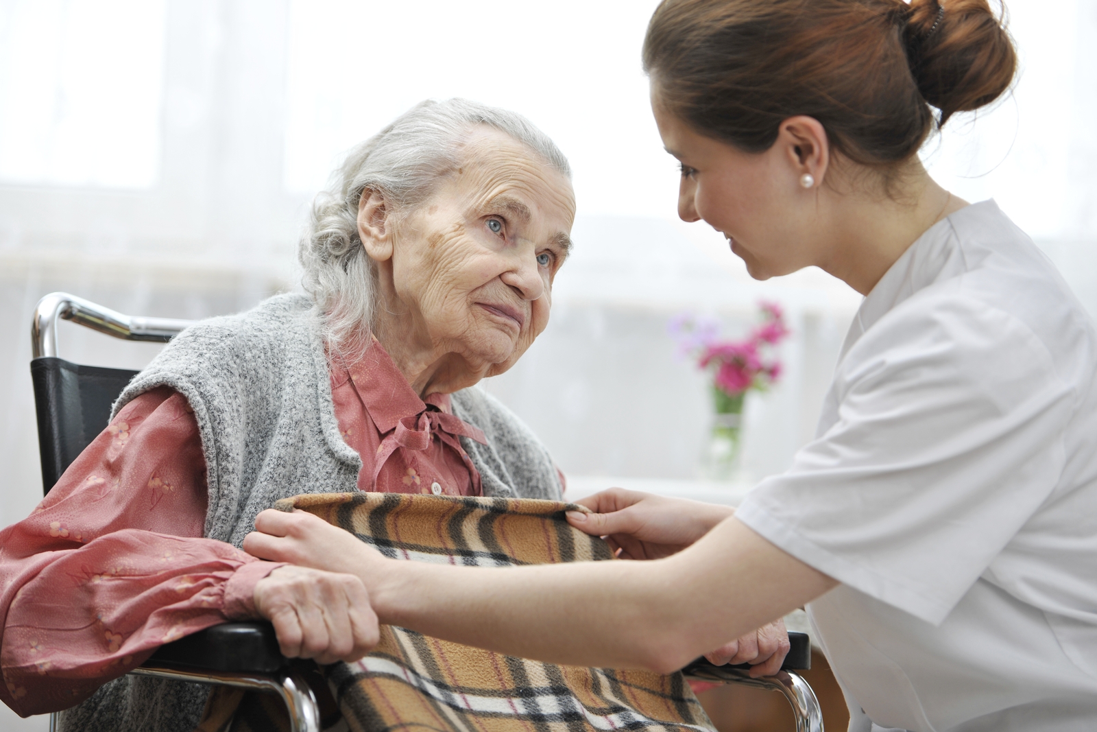 nurse providing care to elderly woman